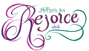 The word "Rejoice" written in purple ink and the scripture Philippians 4:4